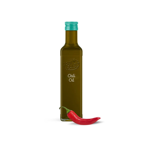 A bottle of chili oil with a teal cap, featuring a front label, positioned next to a vibrant red chili pepper.