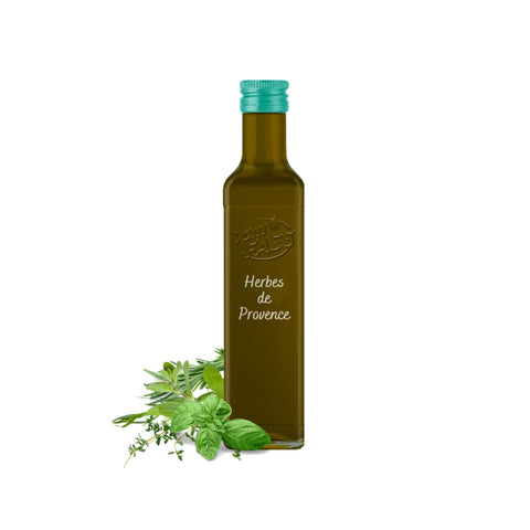 Herbes de Provence extra virgin olive oil in a glass bottle with a green cap, surrounded by fresh herbs.