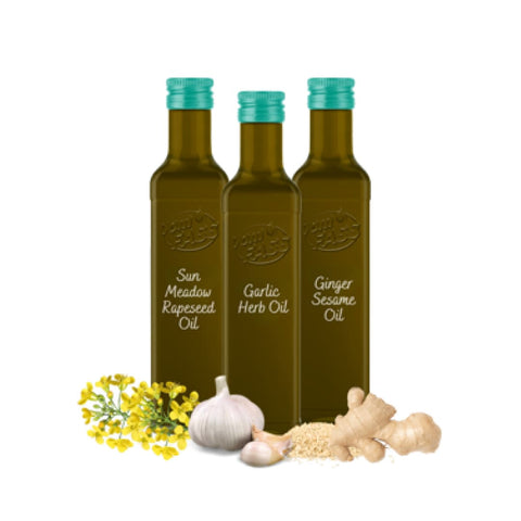 High heat cooking oils set from Vom Fass featuring Sun Meadow Rapeseed Oil, Garlic Herb Oil, and Ginger Sesame Oil bottles.