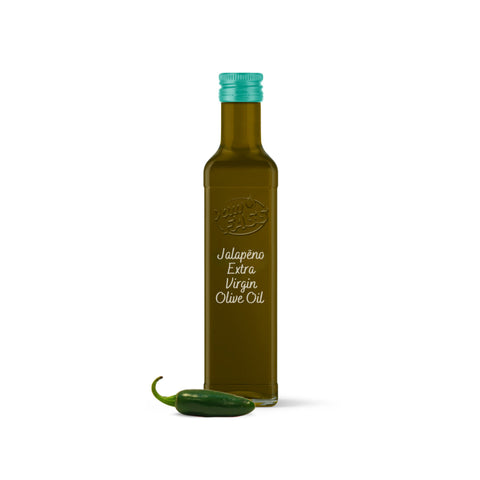 Extra virgin jalapeño olive oil in a glass bottle with a teal cap, accompanied by a fresh jalapeño pepper.